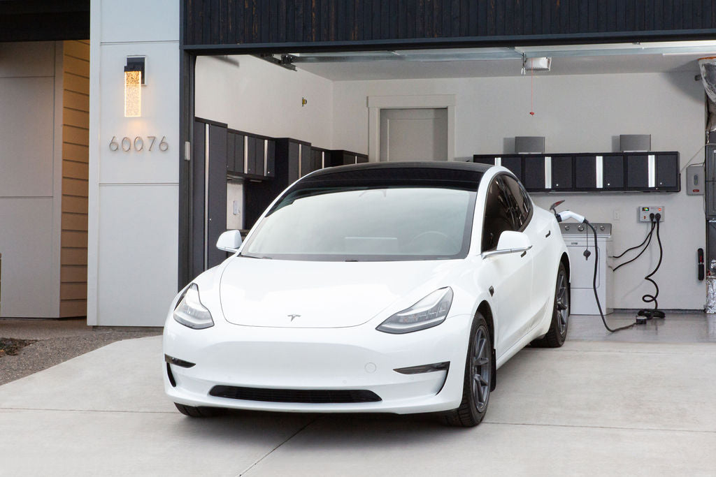 A Tesla being charged using Splitvolt's NEMA 10-30 EV charger extension cable